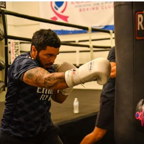 boxer training on heavy bag at boxing gym in Fort Collins focusing on punching technique