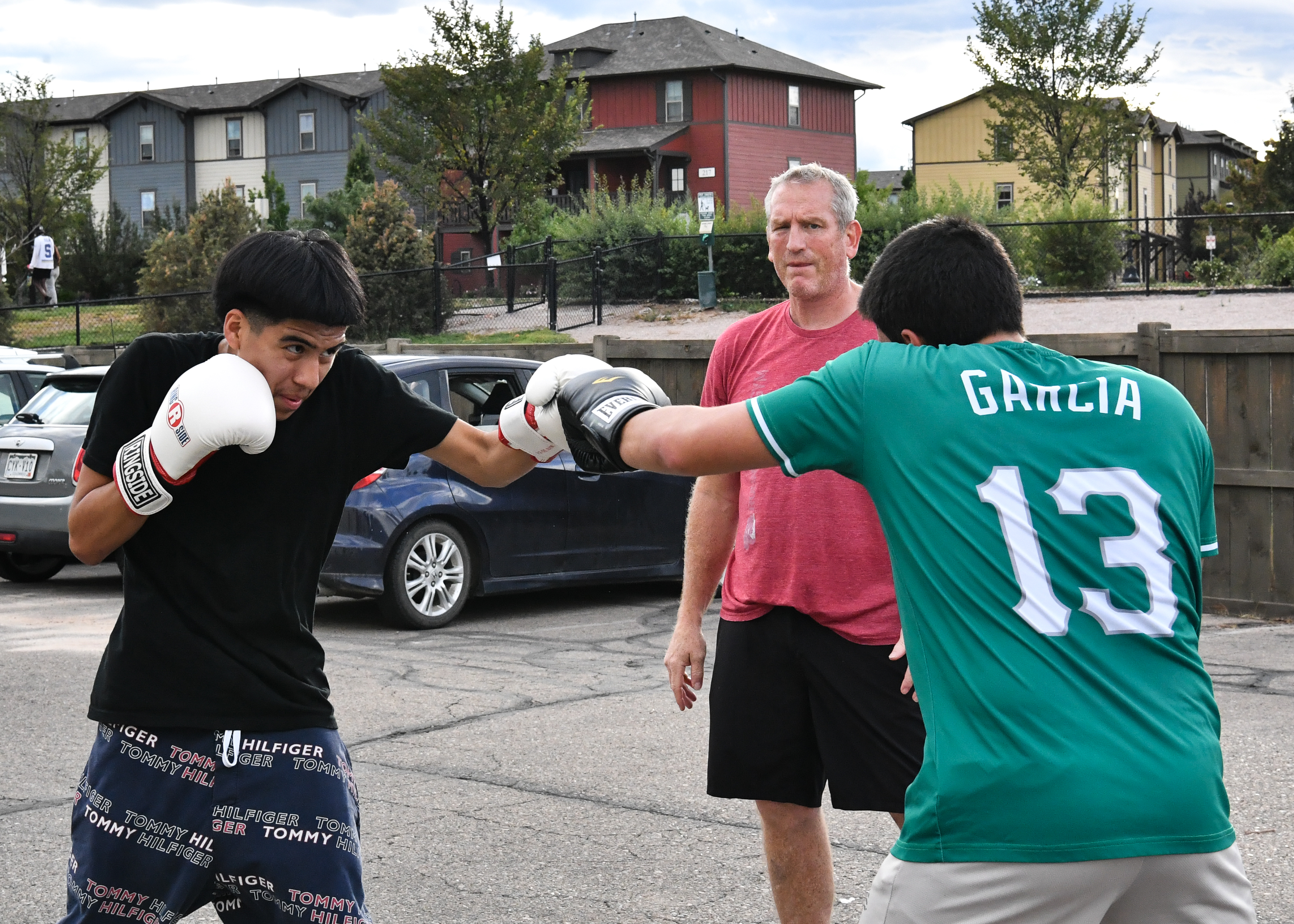 boxing coach demonstrating proper punching mechanics in Fort Collins boxing gym