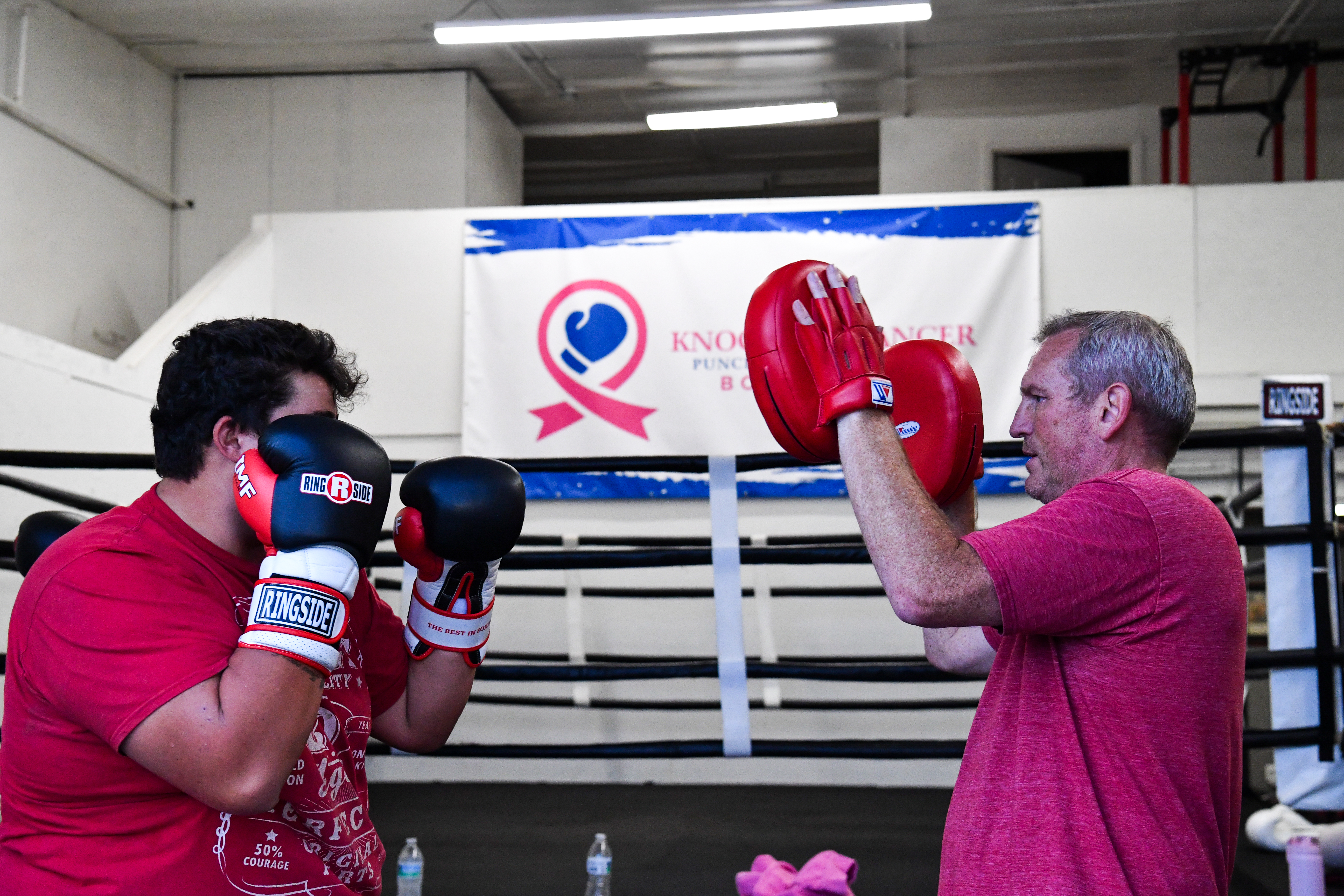 boxing coach training student on speed bag at boxing gym in Fort Collins