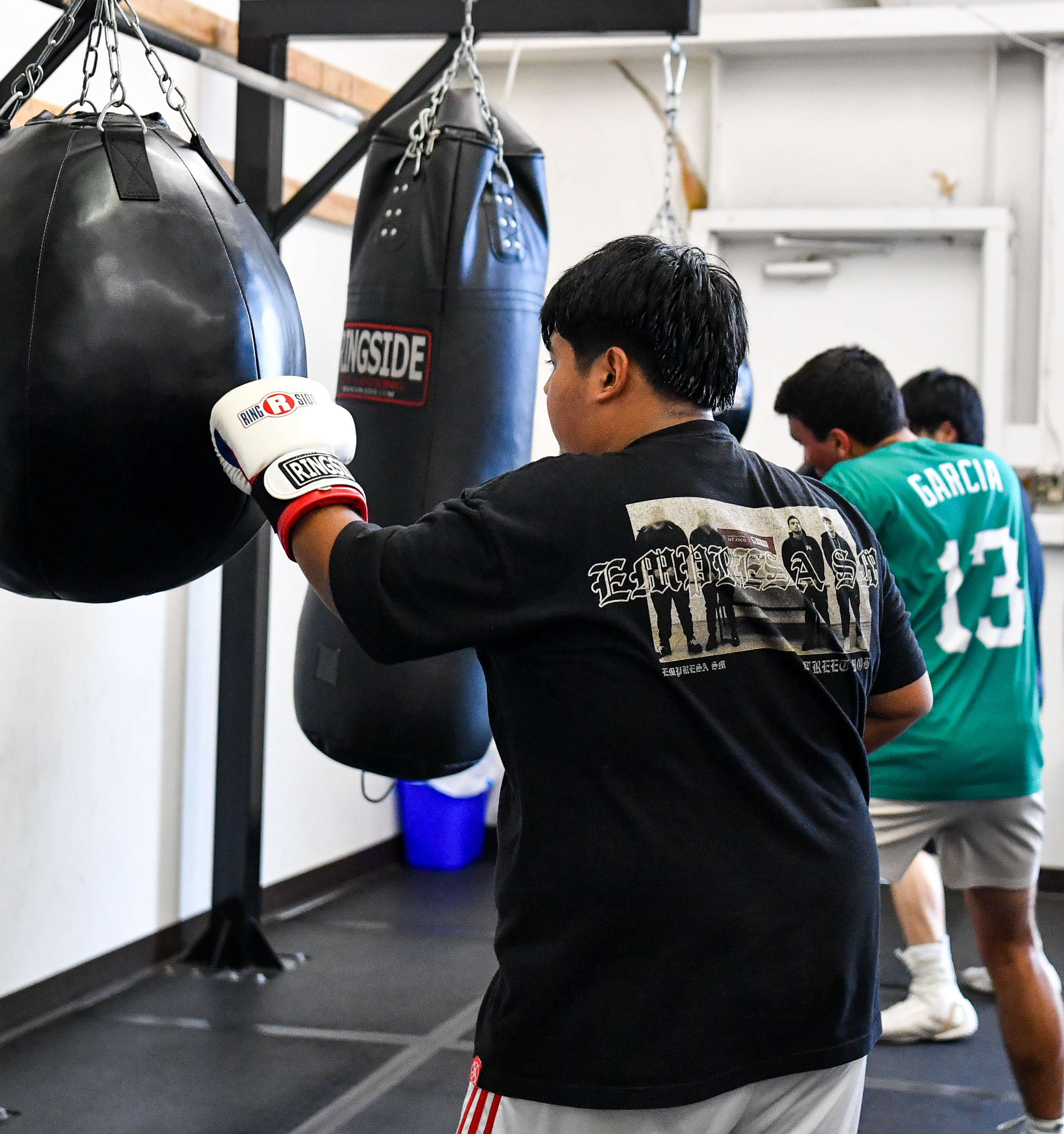 boxer practicing heavy bag drills during boxing class in Fort Collins