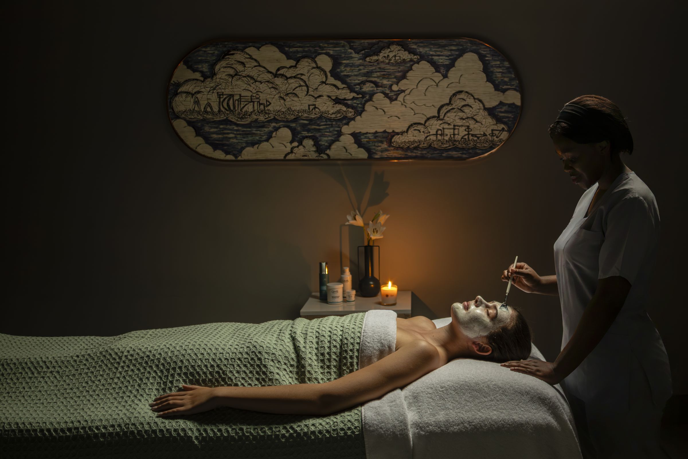 Facial treatment in a candlelit treatment room