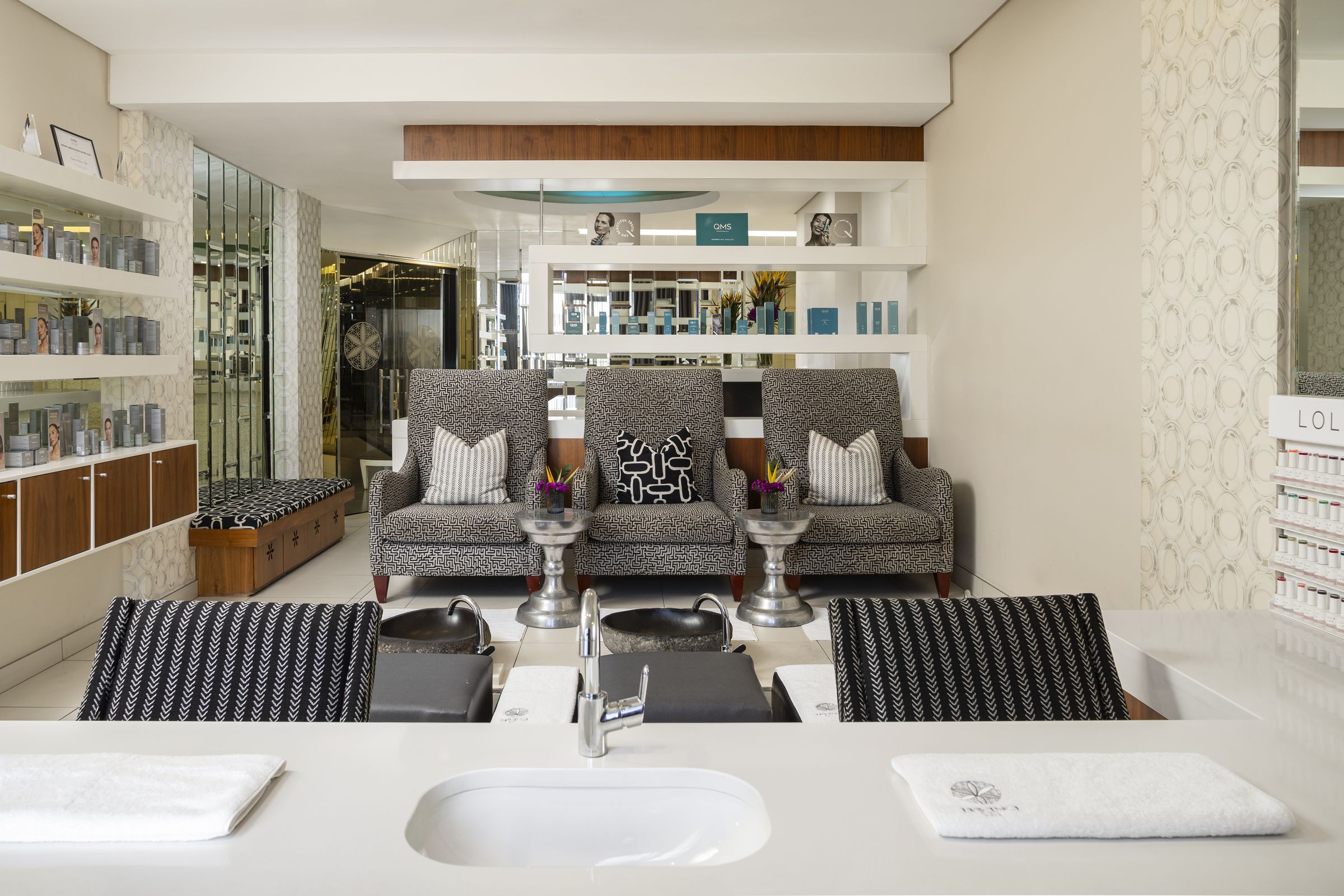 Pedicure lounge with patterned armchairs at Da Vinci Spa