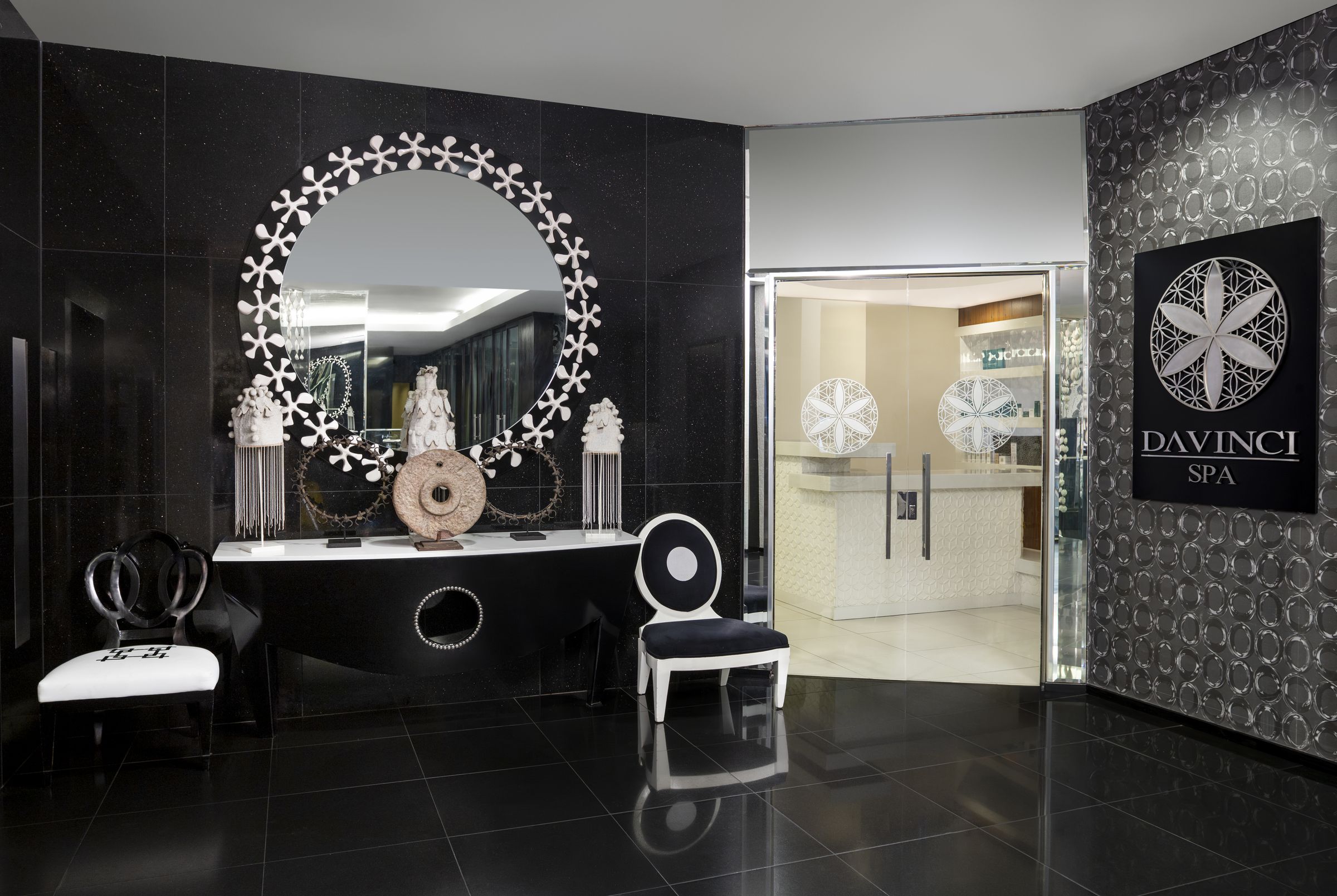 Spa entrance with ornate mirror and black feature wall