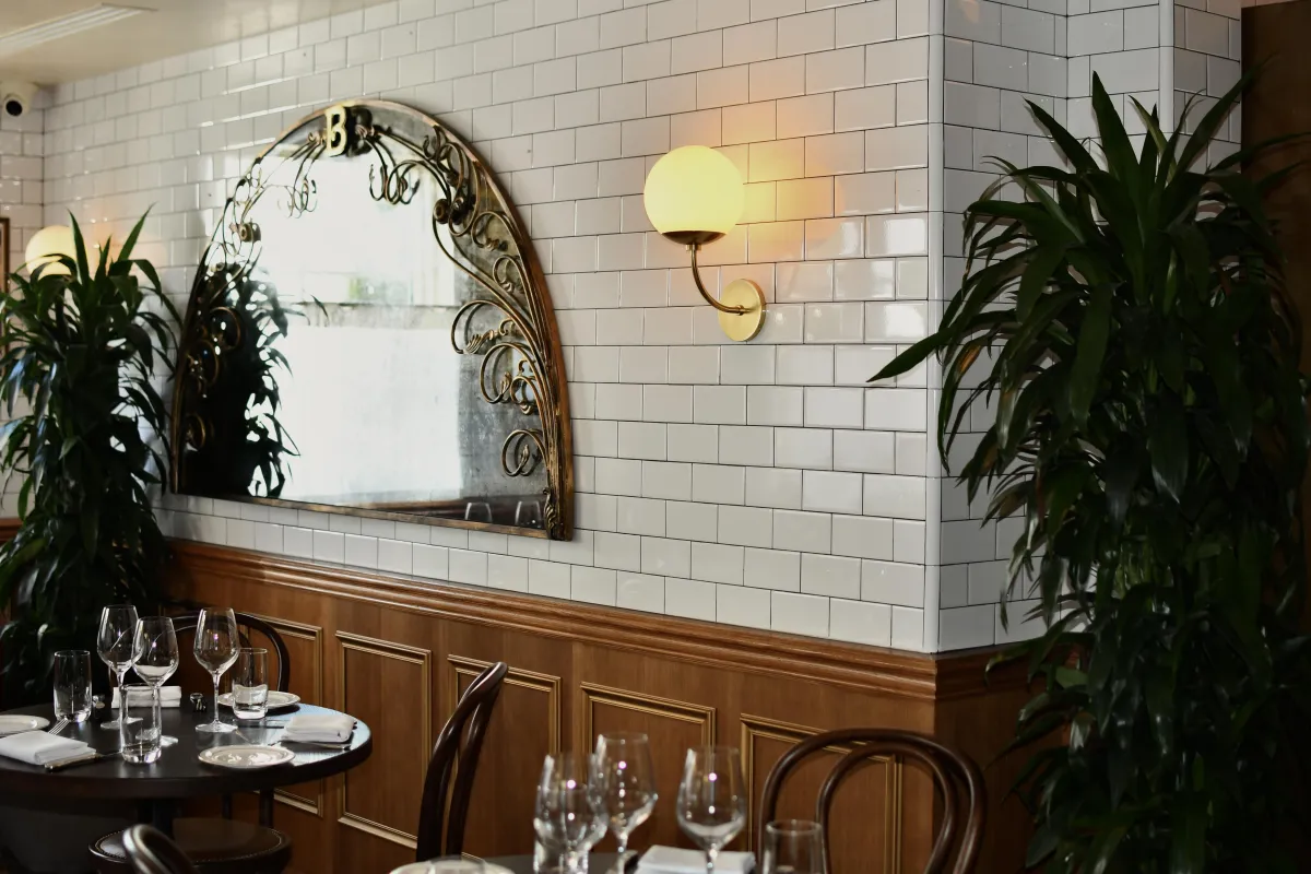 a couch sitting in a living room next to a window