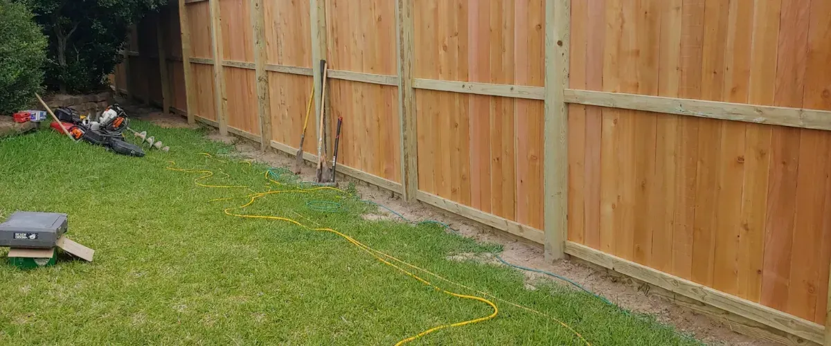 Wood fence installed in front of brick home in College Station TX