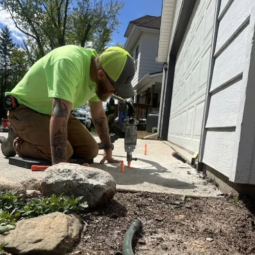 concrete leveling, man fixing concrete slab home repair, step 1