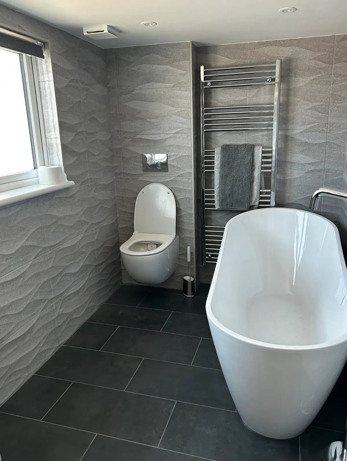 Renovated spa-style bathroom with tile shower