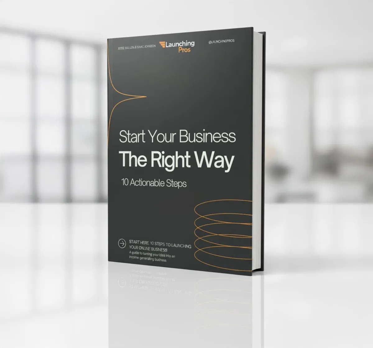 Launching Pros book entitled Start Your Business The Right Way, 10 Actionable Steps sitting on top of a white office counter with blurred background