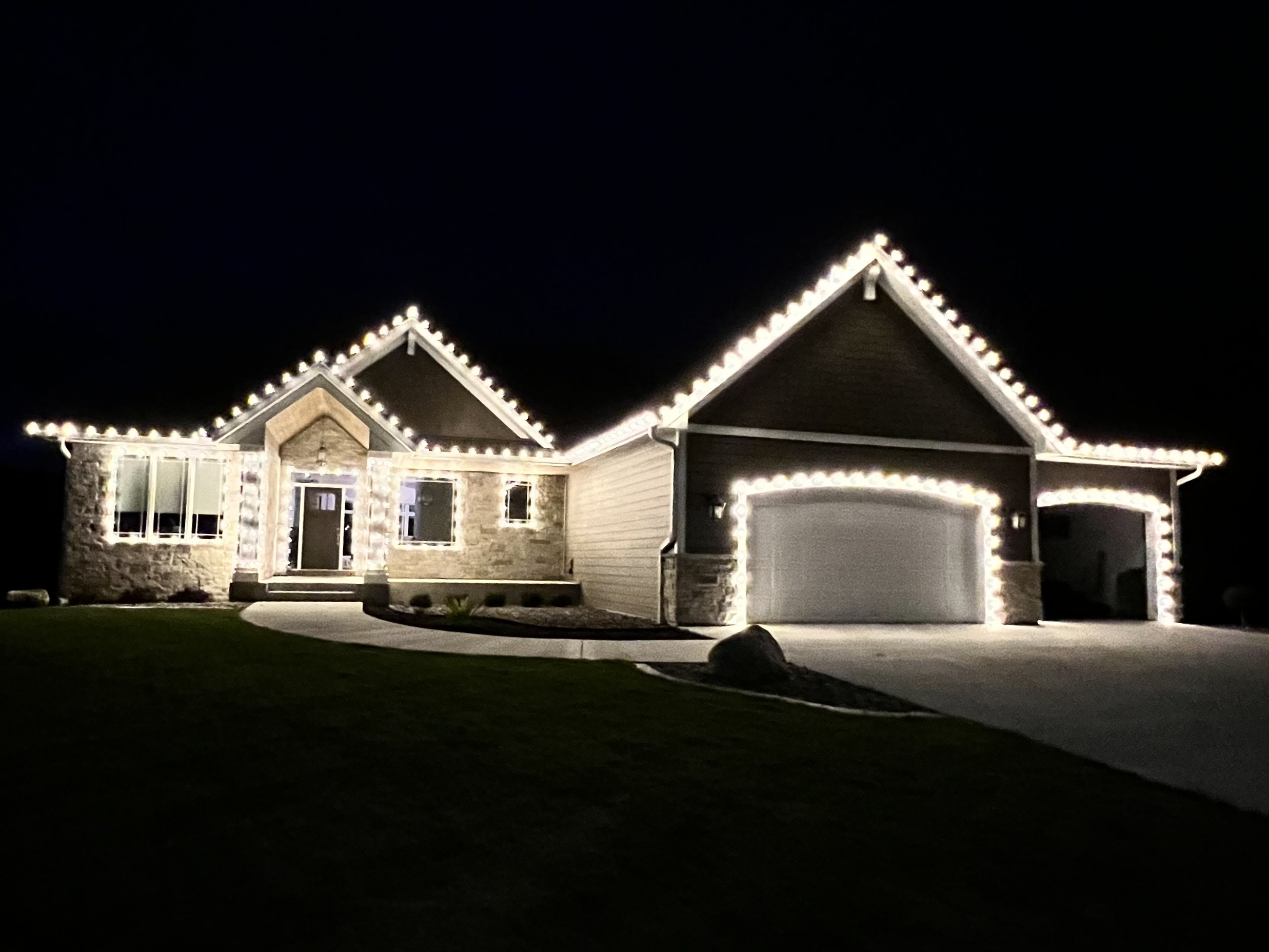 Light Masters seasonal roofline and garage Christmas lighting