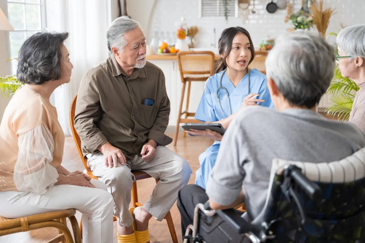 Healthcare mentor reviewing community health metrics and patient consultation data with students in a seminar clinic