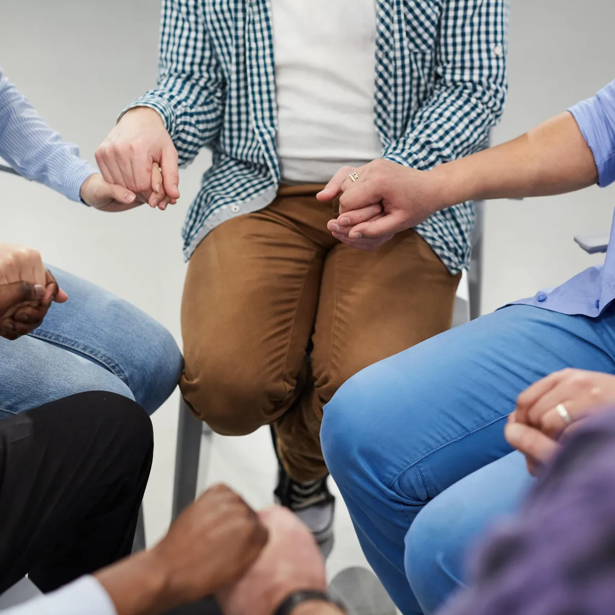 Volunteer leader helping set up chairs in a bright church foyer