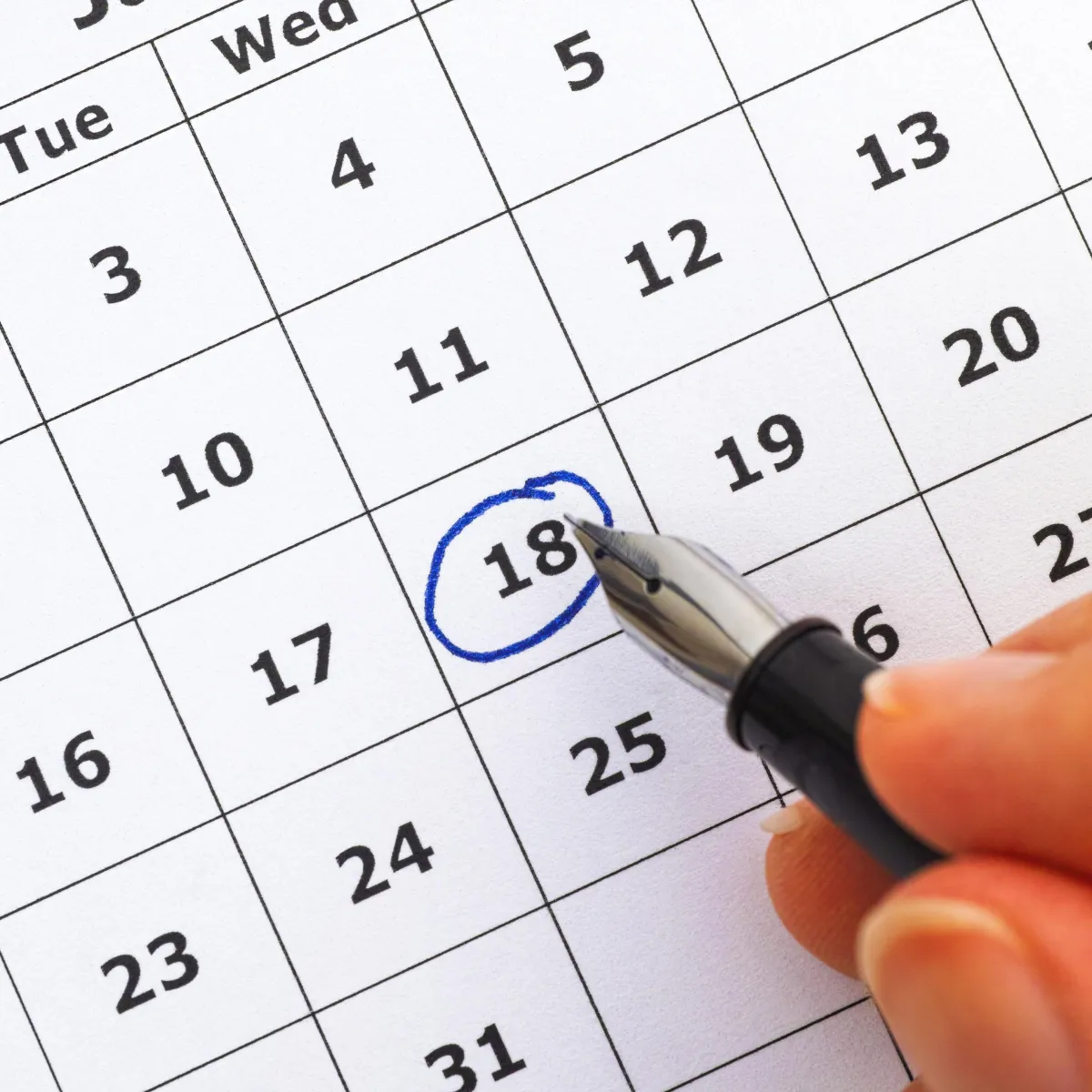 Young family smiling outdoors on a church lawn