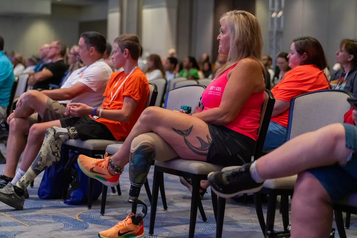 Attendees seated together in a conference session, engaged and participating