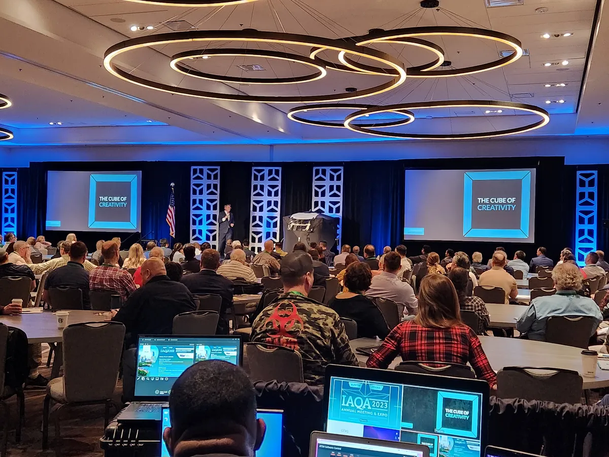 A general session stage with lighting rings above a full audience, run by Lotus