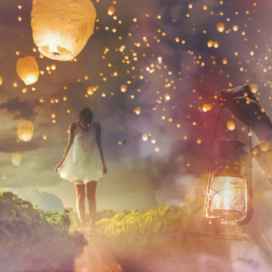 Image of girl walking a path with lanterns lighting her way