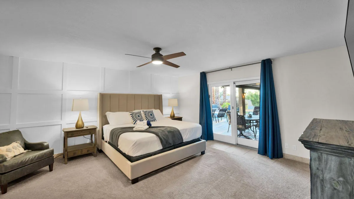 Master bedroom with a king-size bed and private patio access