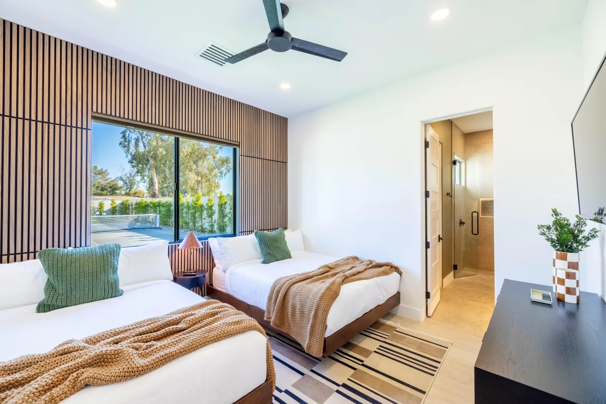 Bright bedroom with modern furnishings and large windows