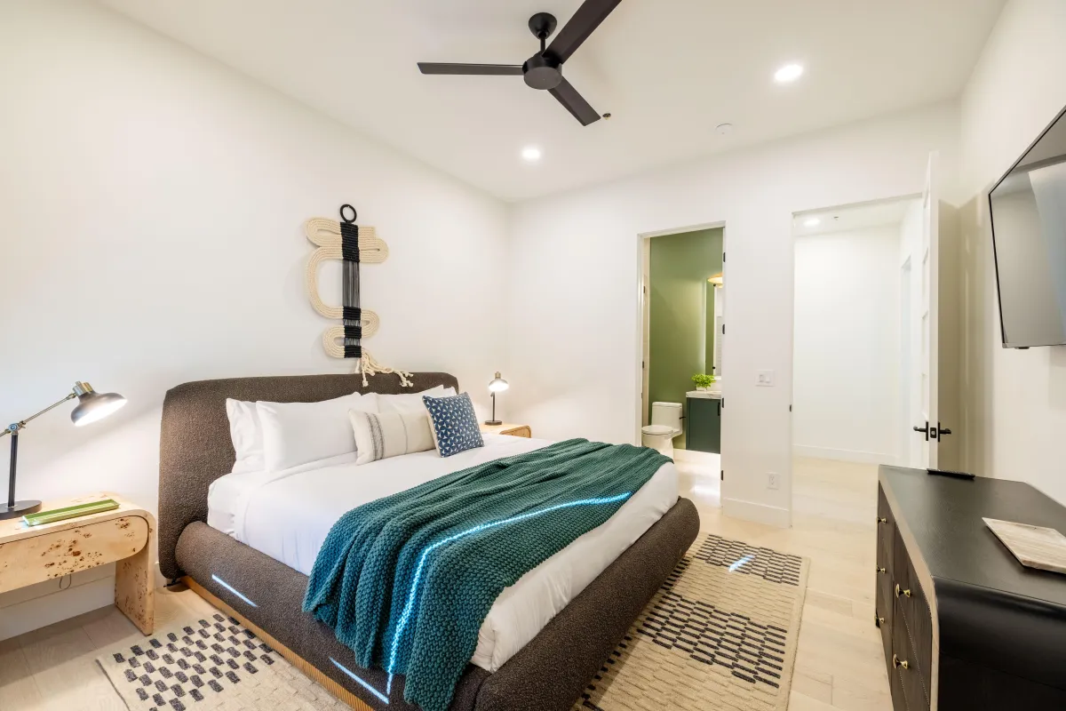 Spacious guest bedroom with cozy linens and stylish decor