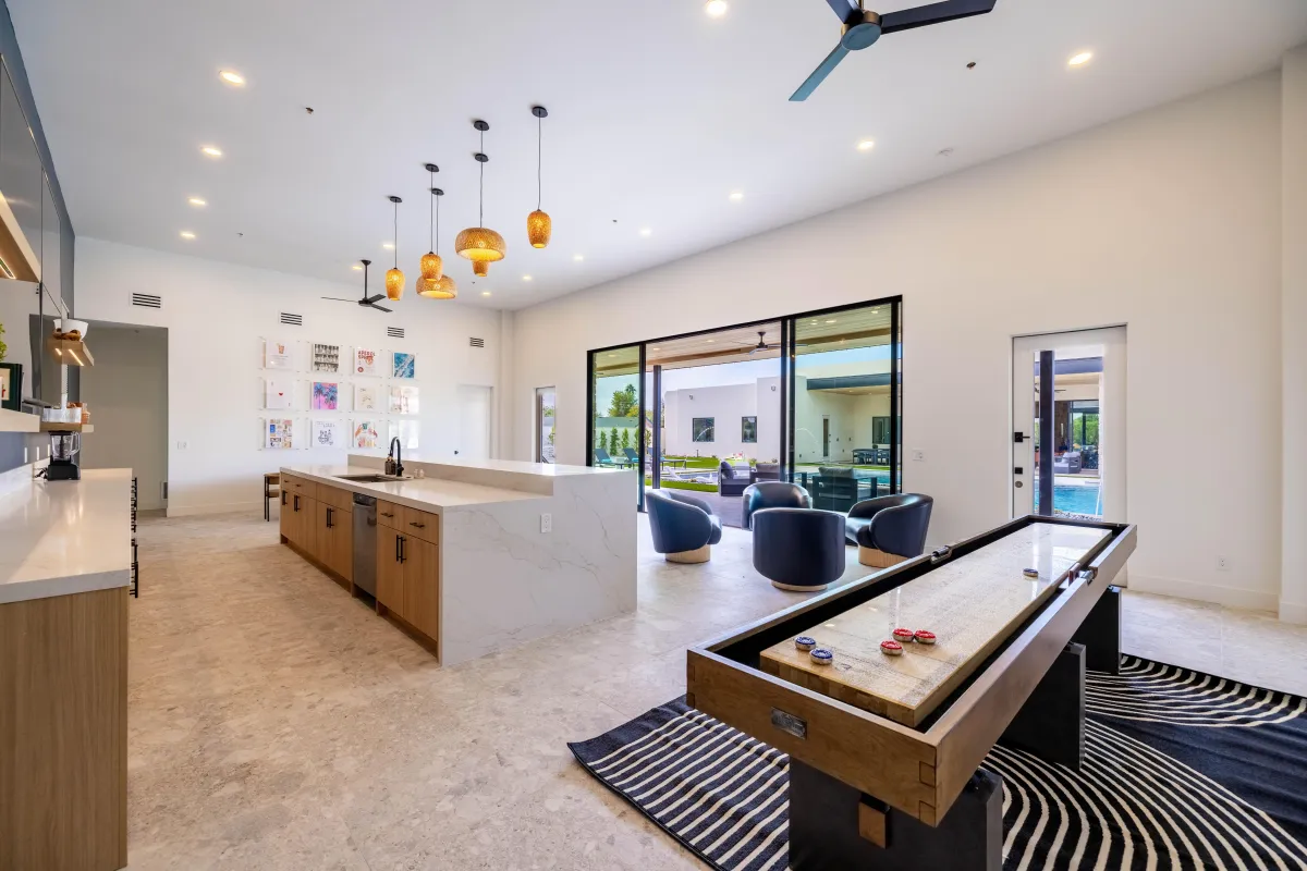 Luxury game room featuring billiards, shuffleboard, and seating