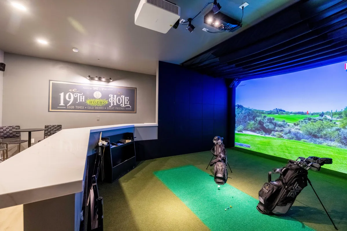 Golf simulator with realistic course settings and comfortable seating