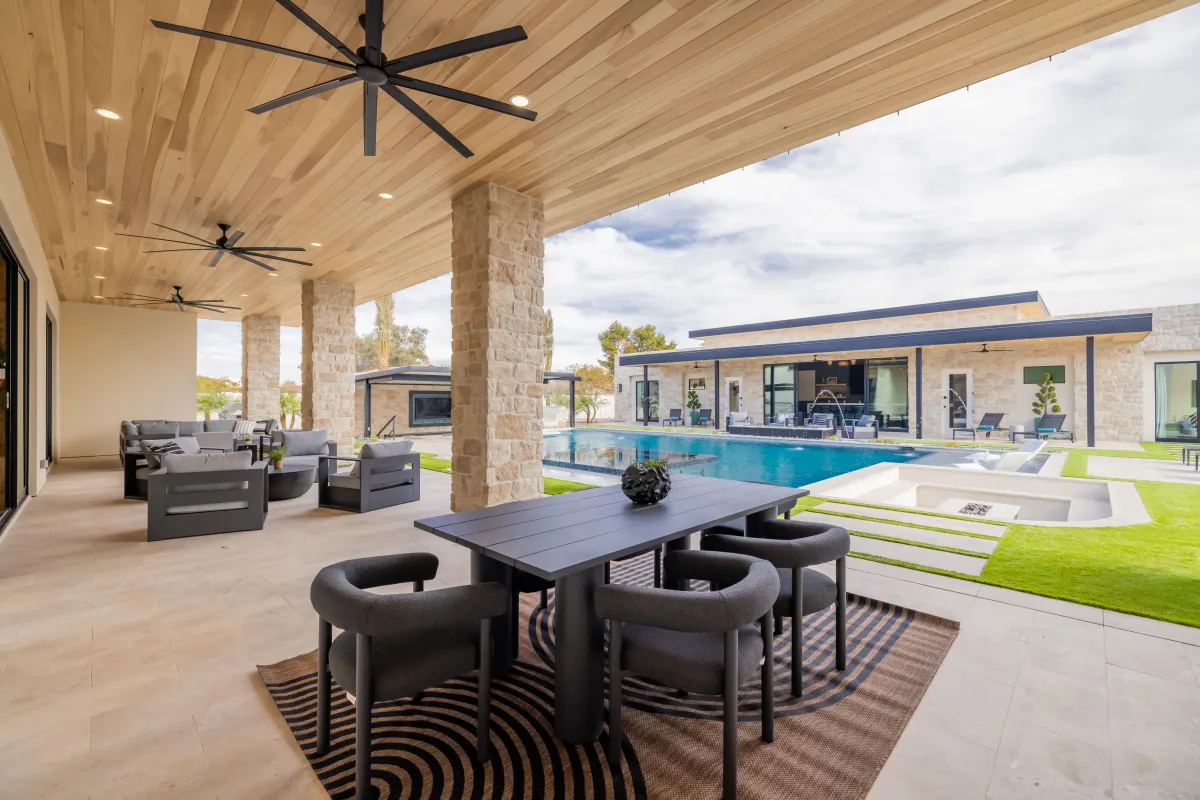 Covered patio with ceiling fans and comfortable sofas