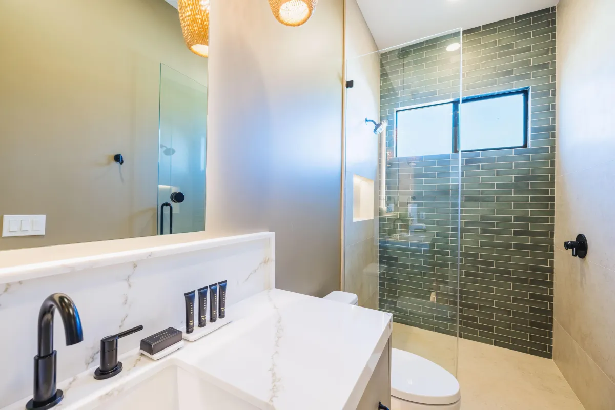 Modern bathroom featuring a walk-in shower and marble countertops