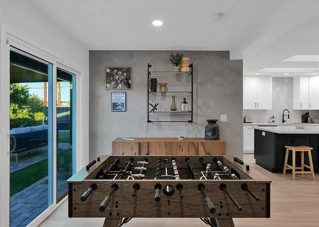 Spacious living room with plush sofas and a large flat-screen TV