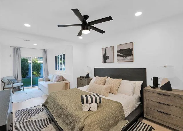 Master bedroom with a king-size bed and private patio access