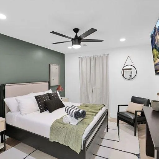 Master bedroom with a king-size bed and private patio access