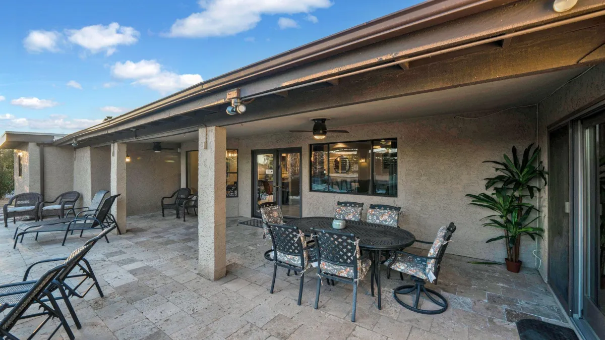 Spacious backyard oasis with multiple seating areas and a BBQ grill
