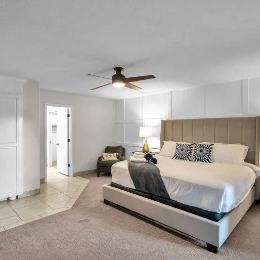 Master bedroom with a king-size bed and private patio access