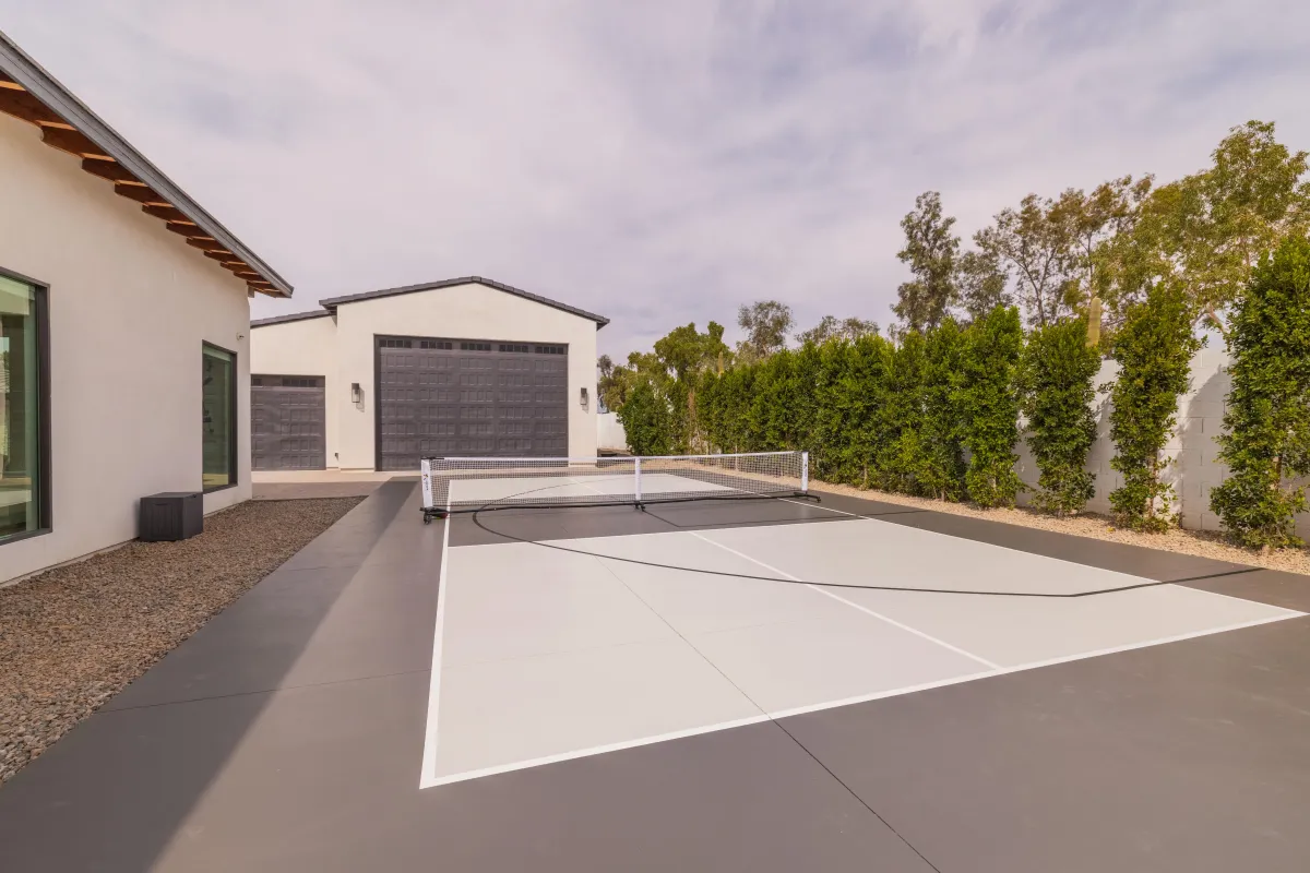 Sport court with Pickleball, Basketball, and putting green in private backyard