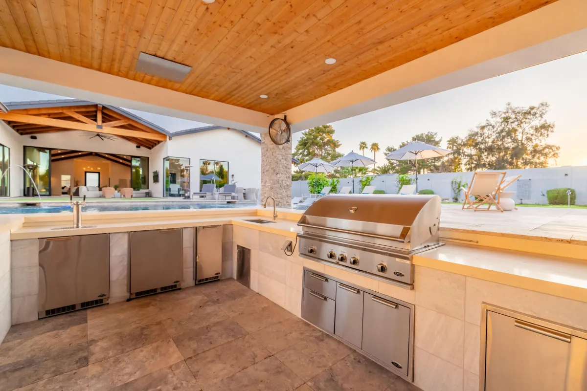 Oasis pool with covered outdoor entertainment