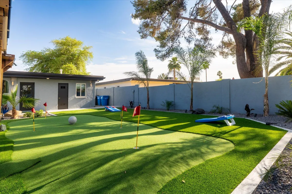 Sport court with Pickleball, Basketball, and putting green in private backyard