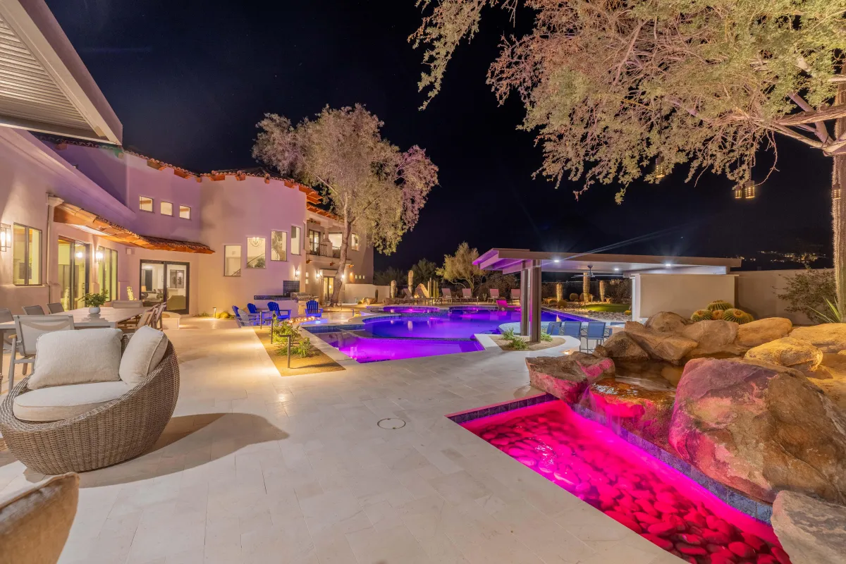 Covered outdoor dining area with grilling station and lounge seating