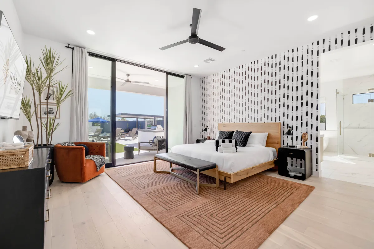 Master bedroom with a king-size bed and private balcony