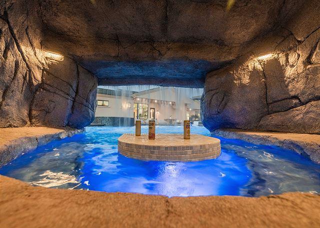 Sunken swim-up bar with shaded seating for poolside drinks