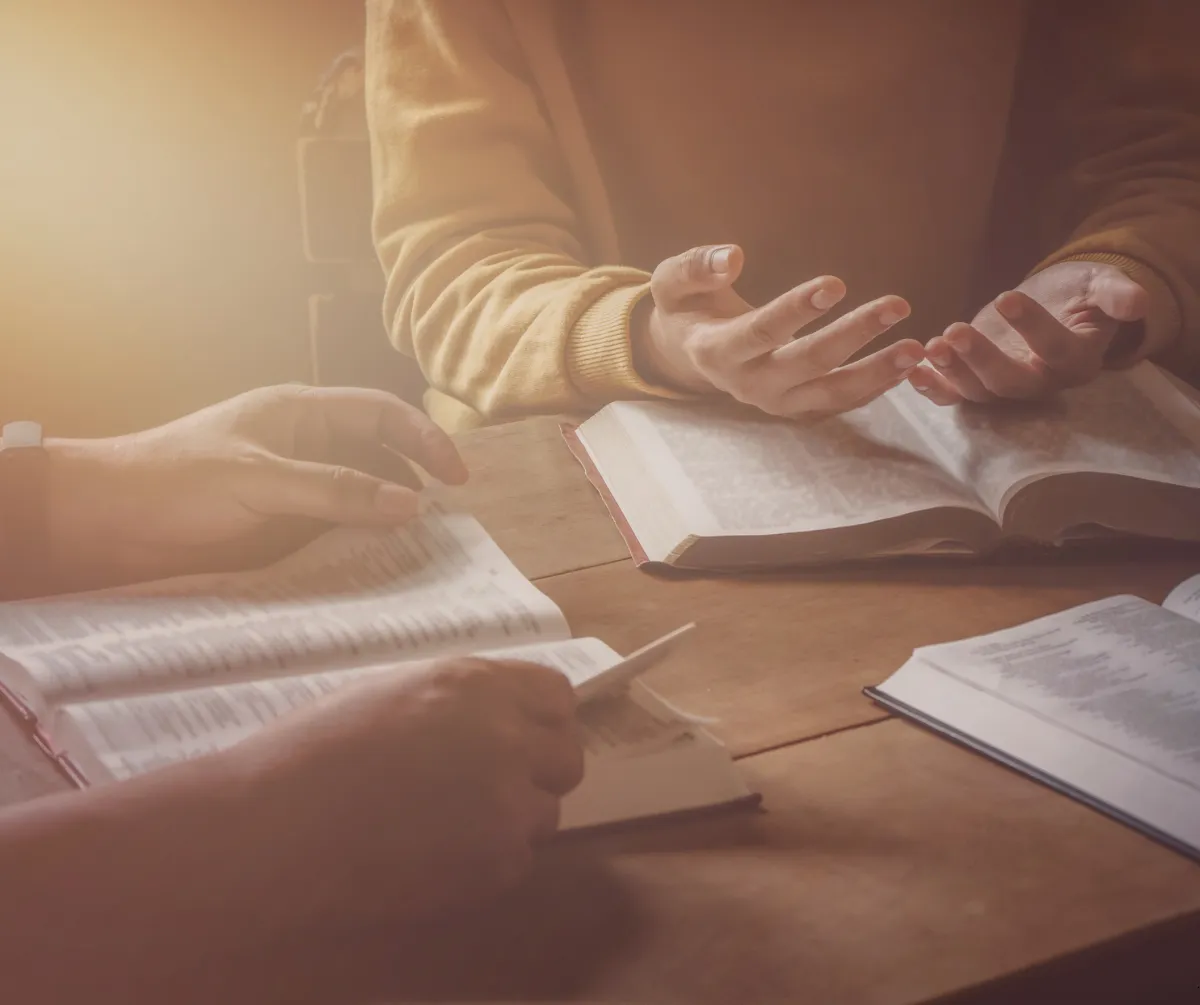 Community hall prepared for a recovery workshop with chairs in a semi-circle and warm daylight.