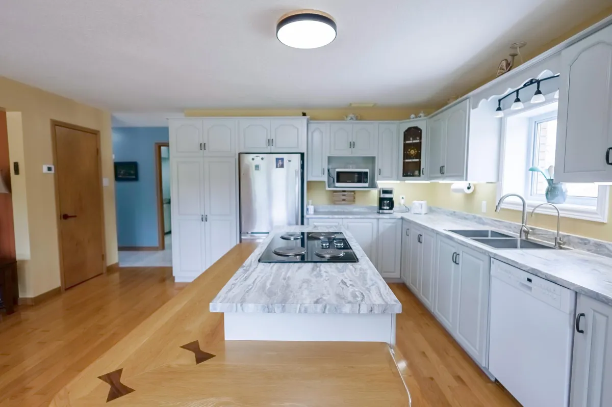 a living room filled with furniture and a kitchen