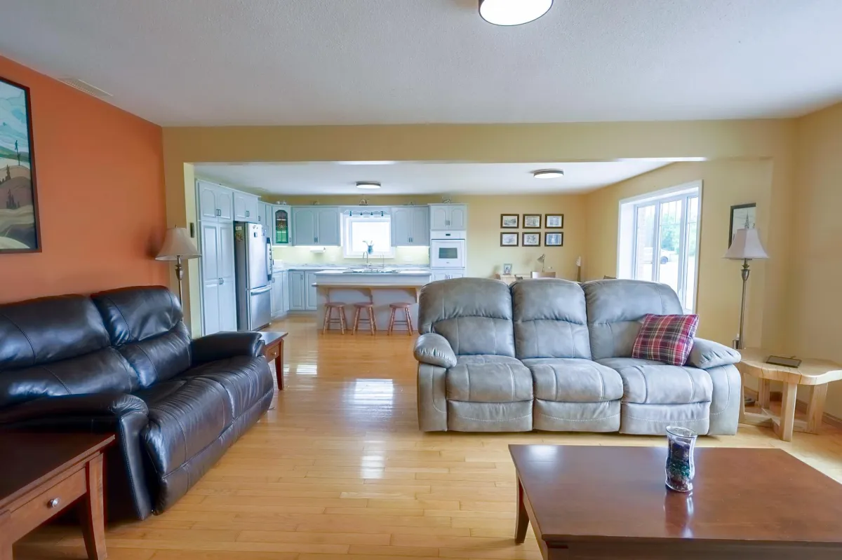 a living room filled with furniture and a kitchen