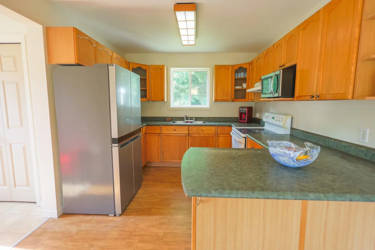 a living room filled with furniture and a kitchen