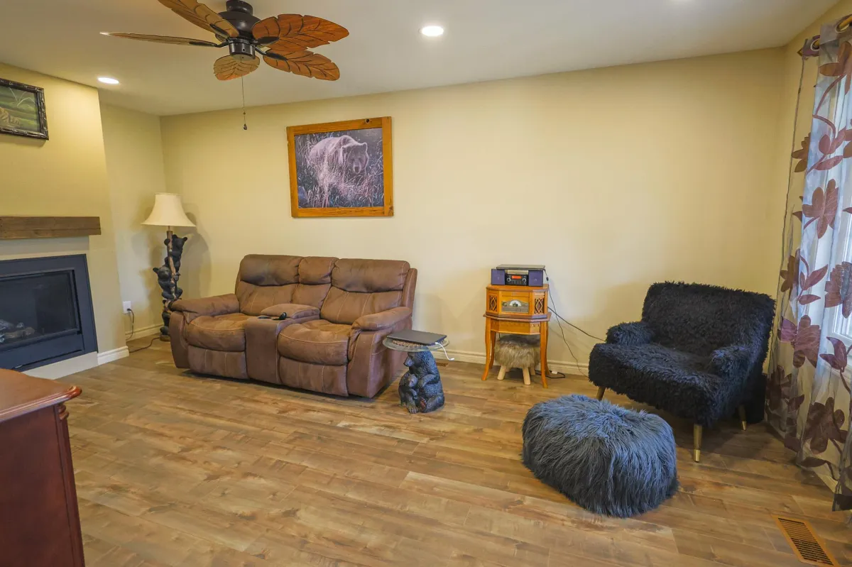 a living room filled with furniture and a kitchen