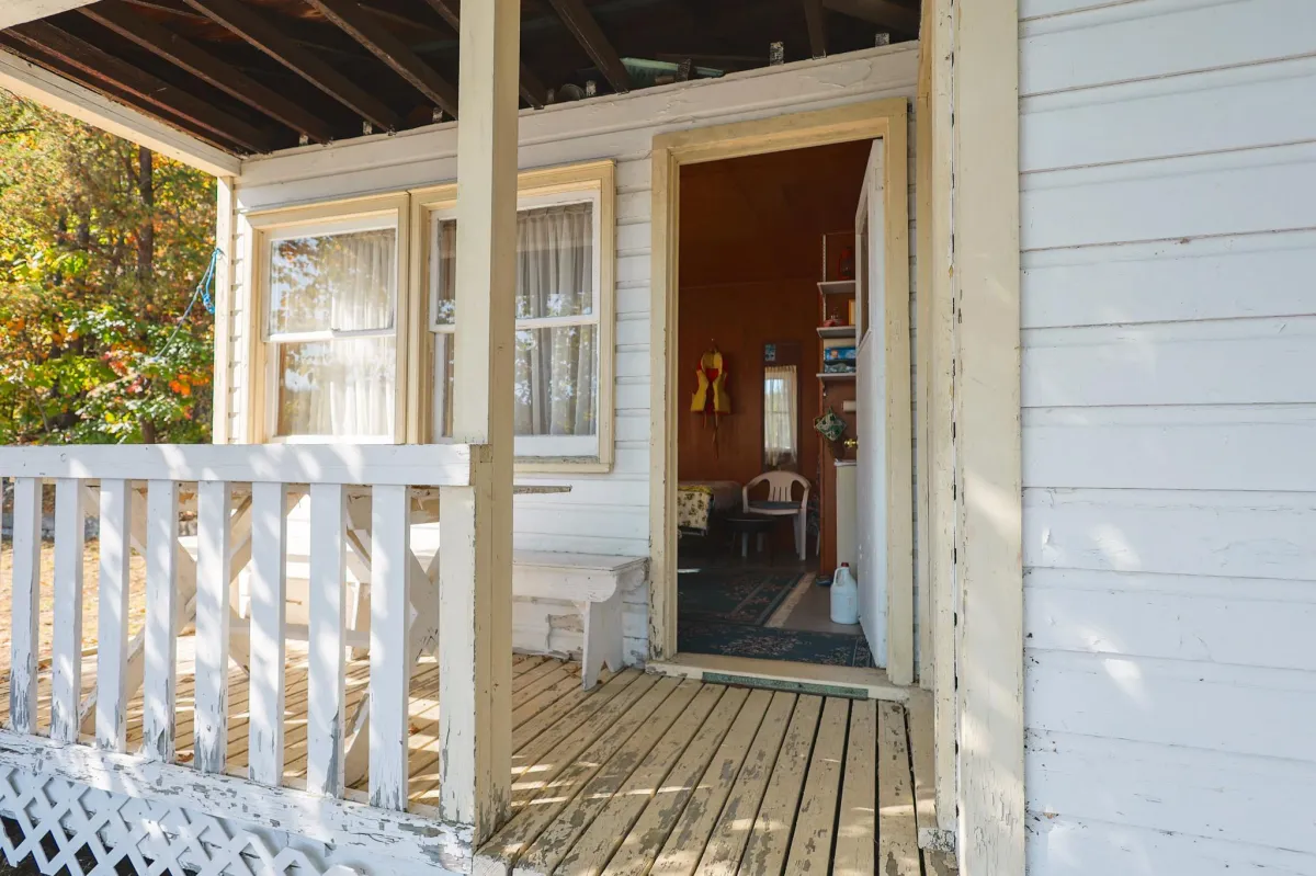 a living room filled with furniture and a kitchen