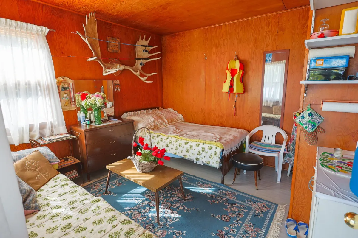 a living room filled with furniture and a kitchen