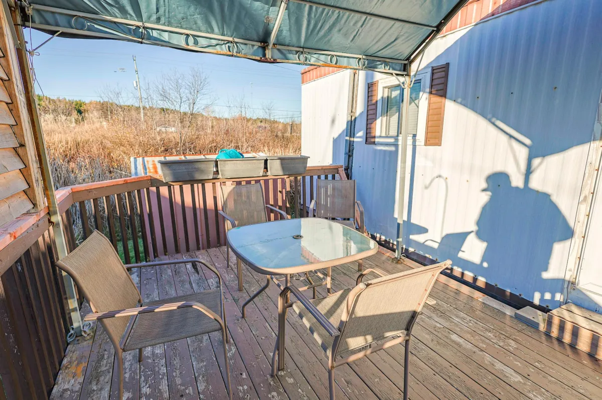 a living room filled with furniture and a kitchen
