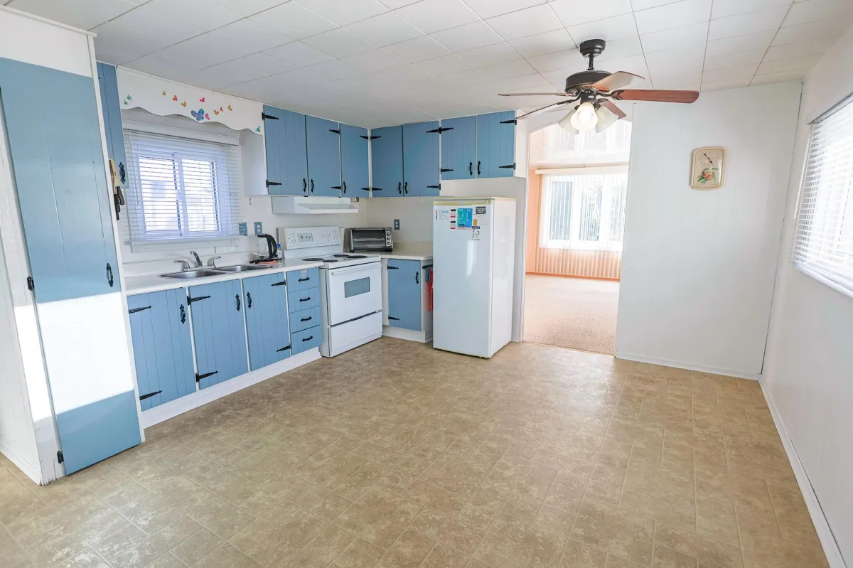 a living room filled with furniture and a kitchen