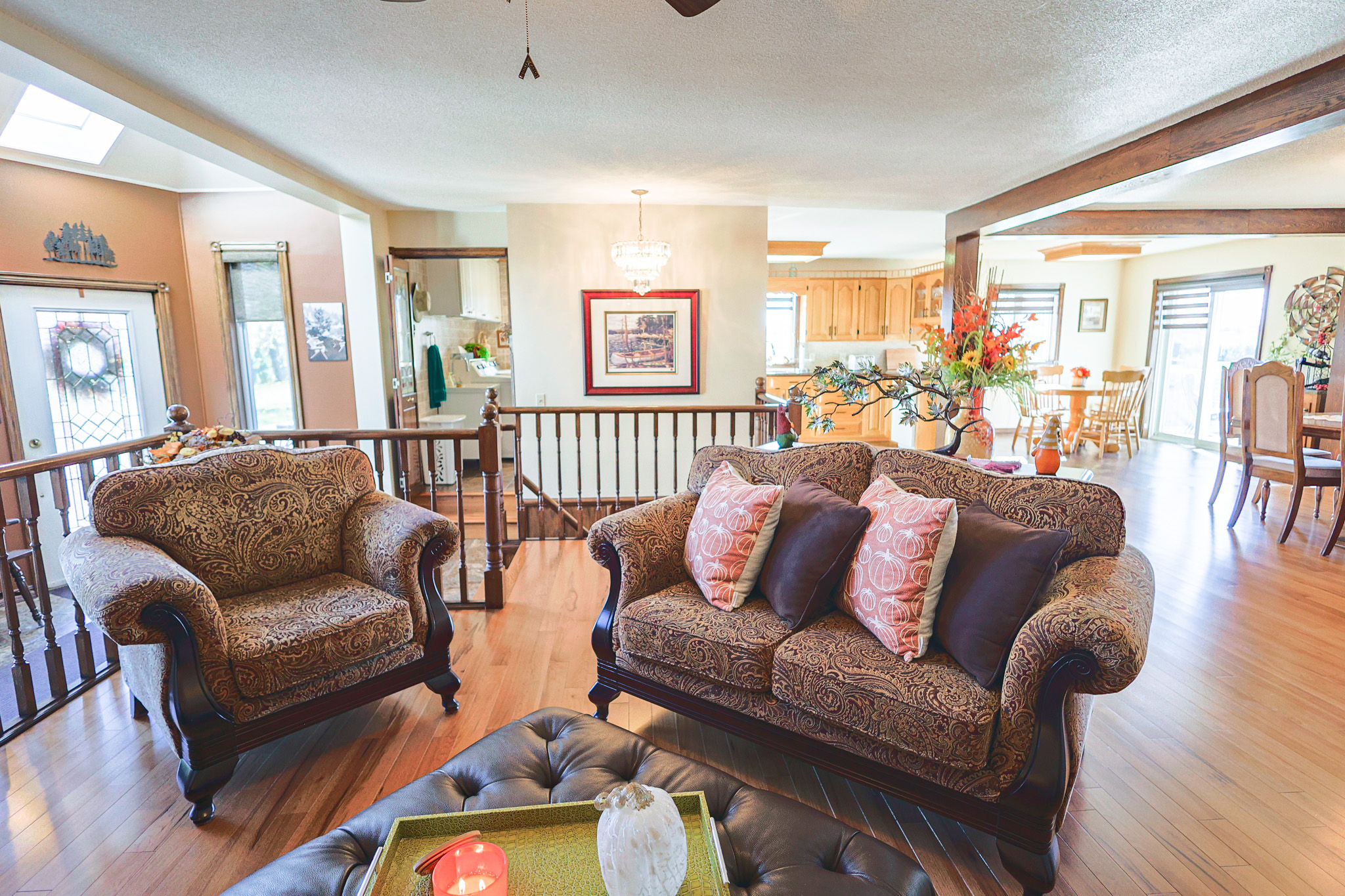 a living room filled with furniture and a kitchen