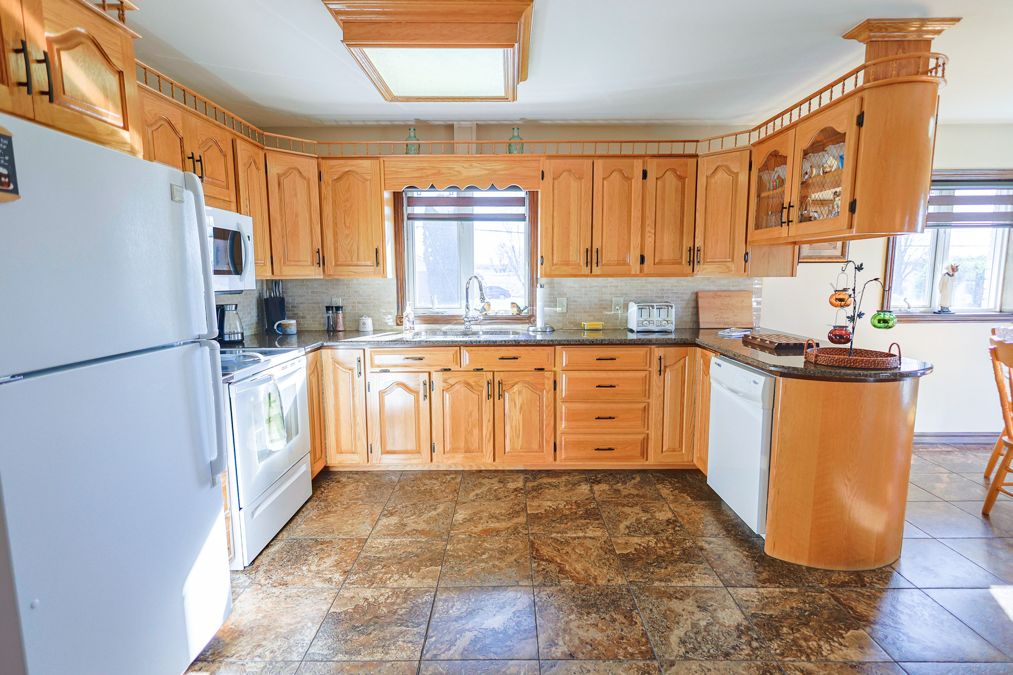 a living room filled with furniture and a kitchen