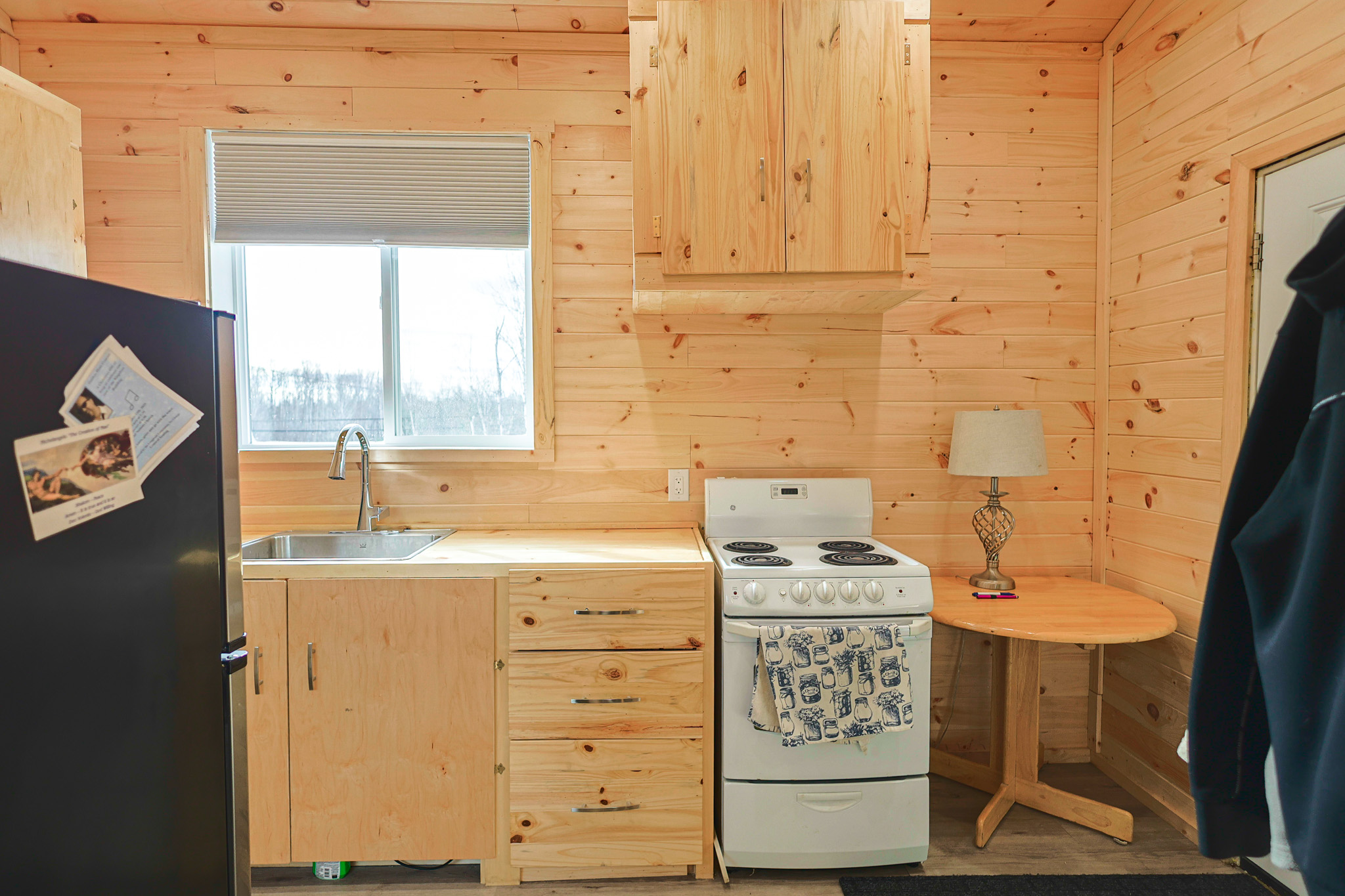 a living room filled with furniture and a kitchen