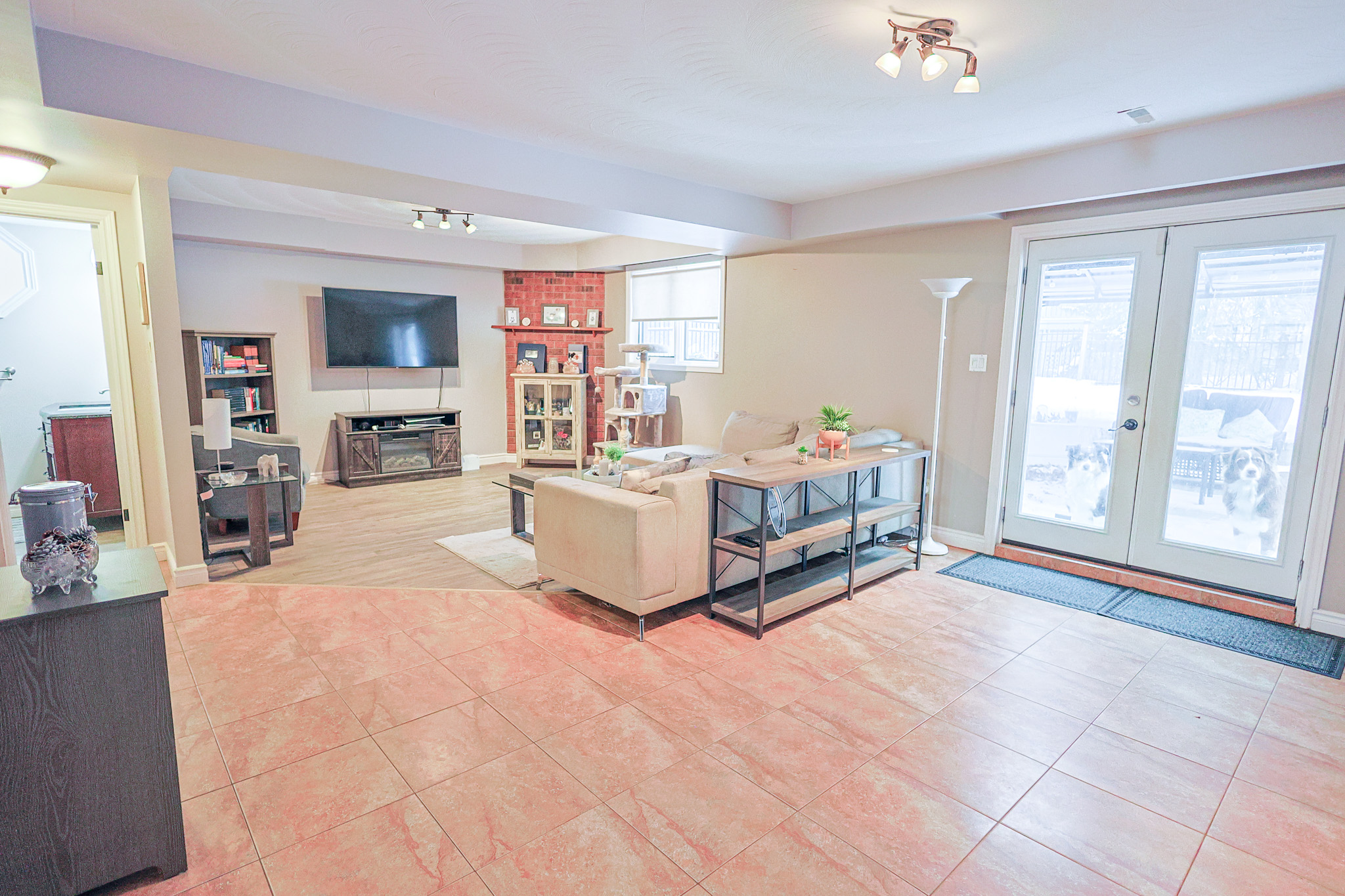 a living room filled with furniture and a kitchen